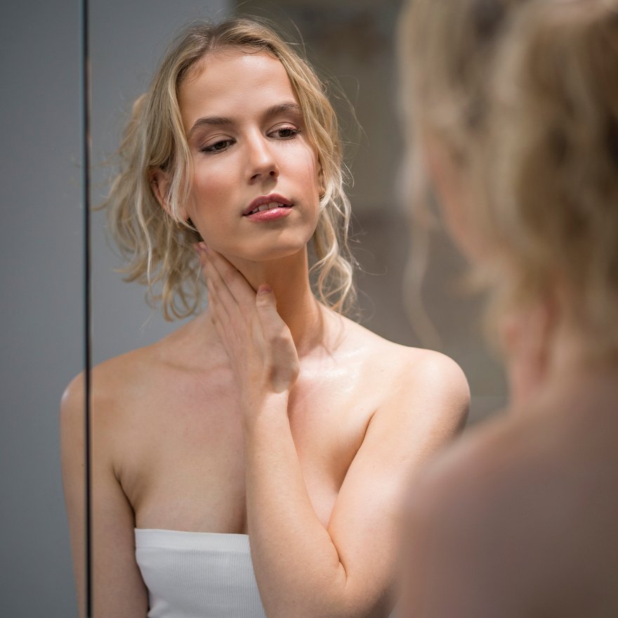 Frau trägt Nachtcreme auf