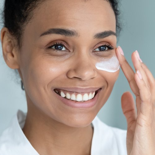 Frau trägt Anti-Aging-Creme auf